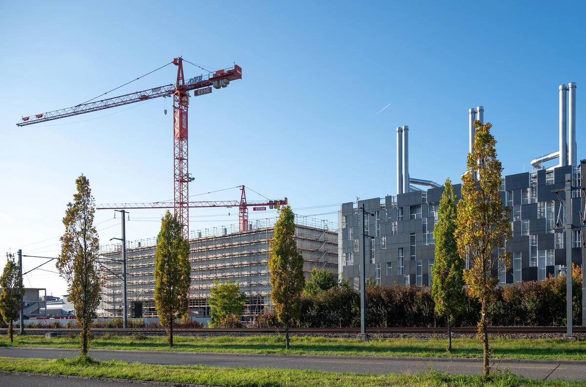 Active data center construction site with cranes and steel framework