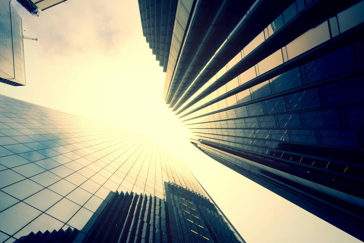 Corporate skyscrapers viewed from below representing institutional capital expenditure